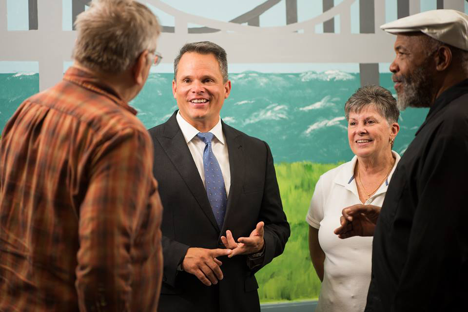Photo of Insurance Commissioner Trinidad Navarro talking with several people